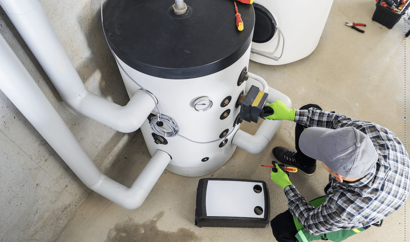 Plumber inspecting a water heater for inconsistent water temperatures.