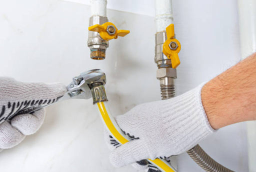 Technician performing gas leak repair on a damaged home gas line